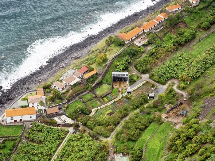 Framed Print : View looking down on cable car on steep coastal cliffs with an organic farm at bottom, Faja dos Padres, Madeira. March, 2023 Framed Print : View looking down on cable car on steep coastal cliffs with an organic farm at bottom, Faja dos Padres, Madeira. March, 2023