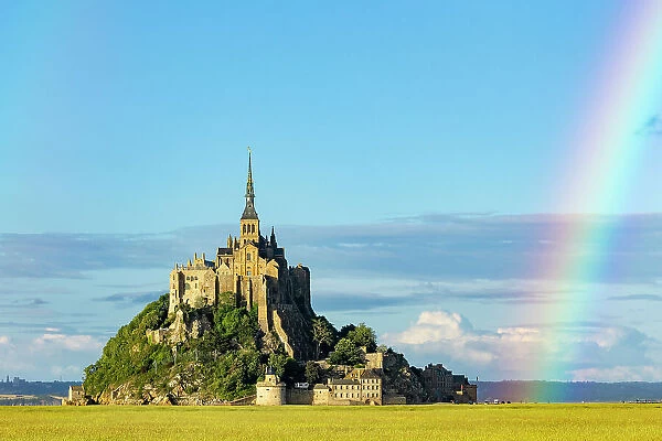 View of Mont Saint-Michel with rainbow in background. Manche, Normandy, France. June