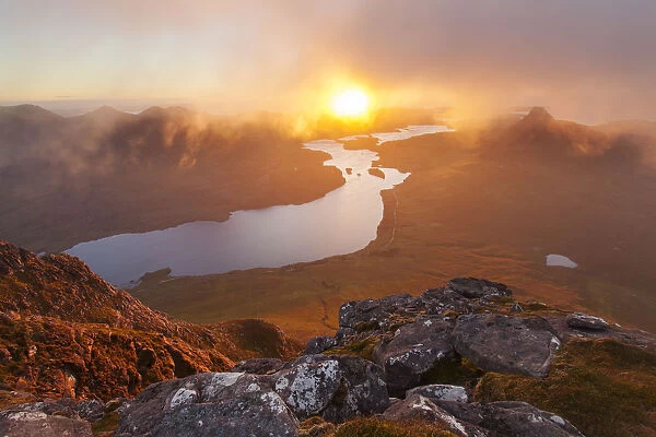 View from summit of Cul Beag overlooking Loch Lurgainn and Stac Pollaidh at sunset