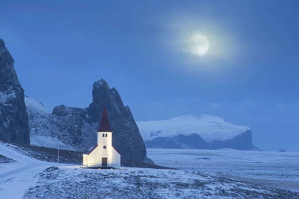 Vik i Myrdal church in winter, with full moon, Iceland. January 2015