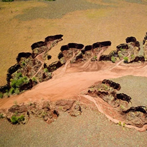 Aerial view of eroded banks and river with suspended load, caused by deforestation