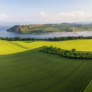 Aerial view of mixed agricultural land, farm buildings and coastline, Black Isle, Highlands, Scotland, UK. June, 2018 Aerial view of mixed agricultural land, farm buildings and coastline, Black Isle, Highlands, Scotland, UK. June, 2018
