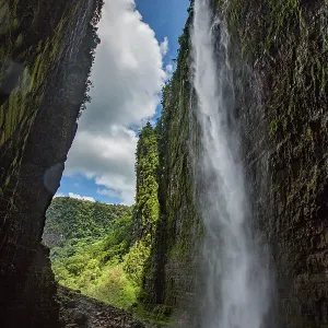 Angel Falls, the world's highest uninterrupted waterfall with a fall of 807m, flowing from Auyan-tepui, a table-top mountain. Helicopter used in filming at base of waterfall with people beside it Angel Falls, the world's highest uninterrupted waterfall with a fall of 807m, flowing from Auyan-tepui, a table-top mountain. Helicopter used in filming at base of waterfall with people beside it