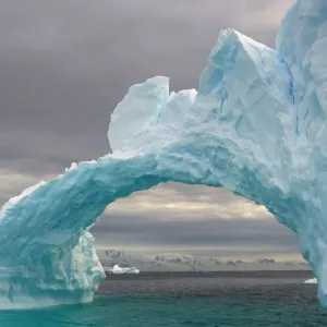 Arched iceberg floating off the western Antarctic peninsula, Southern Ocean Arched iceberg floating off the western Antarctic peninsula, Southern Ocean
