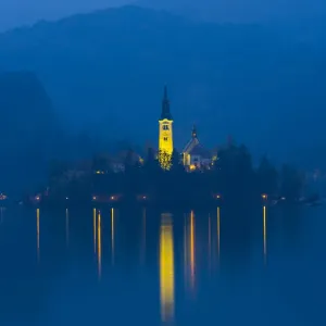 Assumption of Mary Pilgrimage Church, in twilight, reflected in Lake Bled, Bled, Slovenia Assumption of Mary Pilgrimage Church, in twilight, reflected in Lake Bled, Bled, Slovenia