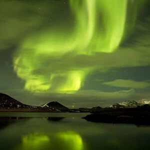 Aurora Borealis display over fjord at night, West Iceland, January 2013