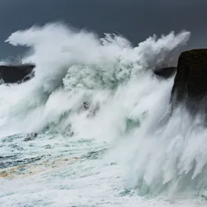 Big storm hitting cliffs, with waves breaking over the top, Shetland, Scotland, UK, July