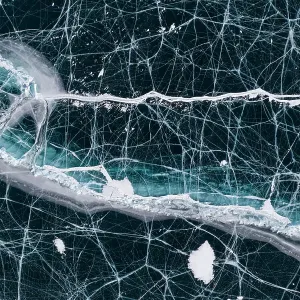 Black ice with cracks on Lake Baikal, aerial shot. Photographed for The Freshwater Project extended. Near Khuzhir, Olchon Island, Irkutsk Oblast and Buryat Republic, Siberia, Russia. February 2019 Black ice with cracks on Lake Baikal, aerial shot. Photographed for The Freshwater Project extended. Near Khuzhir, Olchon Island, Irkutsk Oblast and Buryat Republic, Siberia, Russia. February 2019