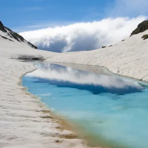 Blue ice melt pool in snow near the peak of La Munia Circo. The Pyrenees, Aragon