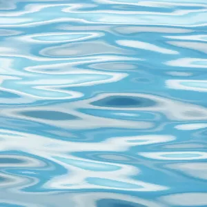 Blue sky reflected in ripples of water, Svalbard, Norway, June 2010