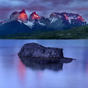 Central Massif and towers of Torres del Paine National Park at sunrise, island reflected
