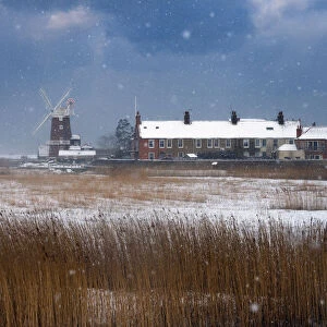 Cley Mill and Reedbed in winter snow storm, Norfolk, UK, February