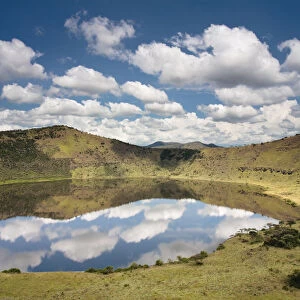 Crater lake with reflections of clouds in the water, Queen Elizabeth National Park