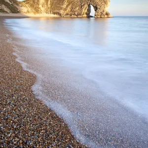 Durdle Door rock arch, evening light, near Lulworth, Dorset, England, UK. April 2010