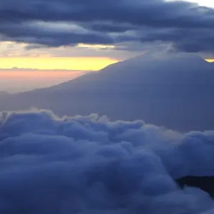 Dusk and clouds on Mount Kilimanjaro with Mount Meru in background (4566m), both volcanos Dusk and clouds on Mount Kilimanjaro with Mount Meru in background (4566m), both volcanos