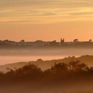 Early morning mist, looking toward Bradworthy village and church, Devon, UK
