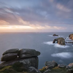 Enys Dodnan Arch, the Armed Knight rock and Longships lighthouse, Lands End, Cornwall, UK