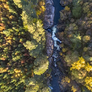 Falls of Truim running through autumnal woodland, Cairngorms National Park, Scotland