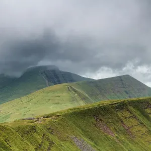 Fan y Big, Cribyn and Pen y Fan viewed from the south east, with storm clouds approaching. These are three glacial cwm's, corries / cirques carved into the Devonian, Old Red Sandstone escarpment, Brecon Beacons National Park, Wales, UK Fan y Big, Cribyn and Pen y Fan viewed from the south east, with storm clouds approaching. These are three glacial cwm's, corries / cirques carved into the Devonian, Old Red Sandstone escarpment, Brecon Beacons National Park, Wales, UK