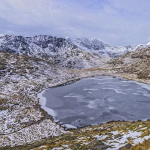 Frozen Llyn Teyrn with Y Llewydd and Mount Snowdon in background. View west from Miners Track