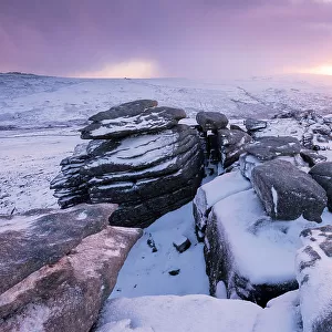 Great Staple Tor covered in snow at dawn, Dartmoor National Park, Devon, England, UK. January 2015