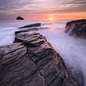 High tide amongst rocks on Trebarwith Strand, at sunset. North Cornwall, England, UK