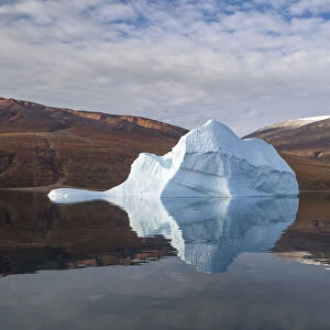 Iceberg and reflection, in Rode Fjord (Red Fjord), Scoresby Sund, Greenland, August