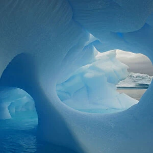 Icebergs with holes in the ice, Iceberg Alley, Pleneau Island, Antarctica