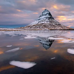 Kirkjufell mountain at dawn with ice in foreground, Snaefellsnes peninsula, Iceland, January 2014