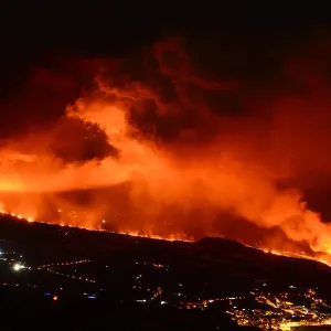 Lava flow and ash from erupting volcano passing close by the village of Los Llanos de Aridane, Volcano Cumbre en Vieja, La Palma, Canary Islands. November, 2021 Lava flow and ash from erupting volcano passing close by the village of Los Llanos de Aridane, Volcano Cumbre en Vieja, La Palma, Canary Islands. November, 2021