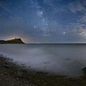 The Milky Way with Saturn and Jupiter in the night sky over Kimmeridge Bay