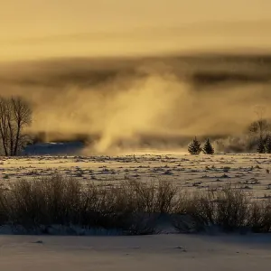 Mist rises from the Snake River on a cold January morning in Grand Teton National Park, Wyoming, USA Mist rises from the Snake River on a cold January morning in Grand Teton National Park, Wyoming, USA