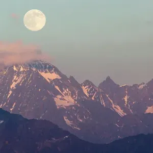 Full moon rising over the Watzespitze (3554m), part of the Glockturmkamm, the westernmost ridge of the Otztal Alps. Nordtirol, Austrian Alps. July. Digitally stitched panorama Full moon rising over the Watzespitze (3554m), part of the Glockturmkamm, the westernmost ridge of the Otztal Alps. Nordtirol, Austrian Alps. July. Digitally stitched panorama