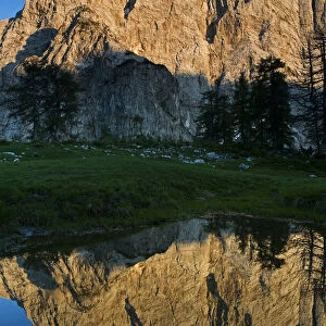 Mount Velika Mojstrovka (2, 056m) with reflection in a pool of water, Sleme, Triglav National Park