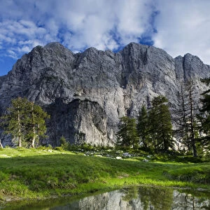 Mount Velika Mojstrovka (2, 056m) reflected in a pool, viewed from Sleme, Triglav National Park