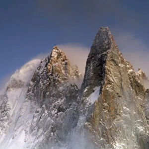 Mountains in snow, Aiguille du Dru with snow blowing off from the top at night. Chamonix