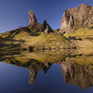 Old Man of Storr reflected in small lochan in morning light