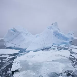 Pack ice and iceberg on sea, Svalbard, Norway, August 2009