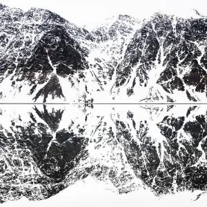 Perfectly mirrored landscape of snow covered mountains along the fjords in Svalbard Perfectly mirrored landscape of snow covered mountains along the fjords in Svalbard