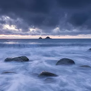 Porth Nanven at dusk, stormy sky and rising tide, The Cot Valley, St Just, Cornwall, UK