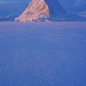 Pyramid of sea ice catching the first rays of the returning sun in the high Arctic