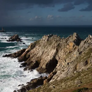 Rain shower approaching La Vieille lighthouse, Pointe du Raz, Brittany, France