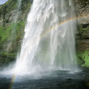 Rainbow in spray of Seljalandsfoss waterfall, Iceland