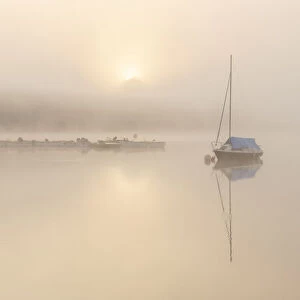 RF - Sailing boat in mist at sunrise, reflected in Wimbleball Lake