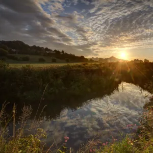 River Brue, at sunrise with Glastonbury Tor in background, Somerset, UK, August