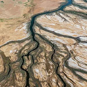 Rivers/water channels form and water flows into Lake Eyrer North as a result of uncommonly high desert rainfall. Lake Eyre North, South Australia, March 2022