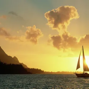 Sailing yacht at sunset off coast of Hanalai Bay, Kauai, Hawaii, USA Sailing yacht at sunset off coast of Hanalai Bay, Kauai, Hawaii, USA