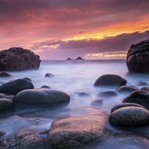 Sea and stones at Porth Nanven beach, with rising tide at sunset, The Cot Valley