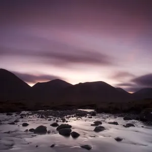 Silhouettes of the Red Cullin at dawn, with stream in the foreground, Isle of Skye Silhouettes of the Red Cullin at dawn, with stream in the foreground, Isle of Skye