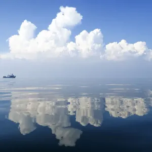 Small Boat Print on Calm Waters with Cloud Reflections Small Boat Print on Calm Waters with Cloud Reflections